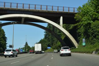 Northbound Interstate 5 continues with four lanes across Olympia to Exit 108.