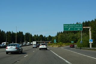 Henderson Boulevard curves northward below I-5 and 14th Avenue SE en route to Plum Street. Plum Street extends north to East Bay Drive near the Port of Olympia.