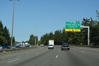 A lane drop occurs along Interstate 5 northbound for Exit 108 to Sleater-Kinney Road and College Street.