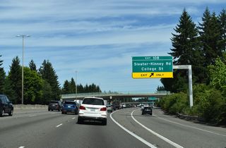 Gore point signs assign the ramps for Sleater-Kinney Road south as Exit 108 A and north as Exit 108 B. The continuation of the distributor lane to the intersection of 3rd Avenue SE and Golf Club Road SE is unnumbered.