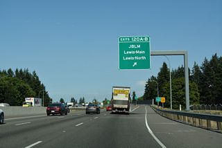 A c/d roadway separates from I-5 north for the cloverleaf interchange (Exits 120 A/B) with 41st Division Drive to Joint Base Lewis-McChord (JBLM).
