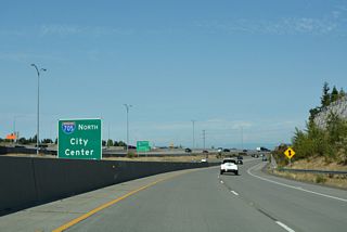 Ramps from the east end of SR 16 and the c/d roadway at Exit 132 combine with the ramp from Exit 133 ahead of Interstate 705.