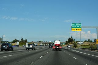 Exit 136 A joins Port of Tacoma Road south to parallel 20th Street E. 20th Street leads east by a series of warehouses in Fife.
