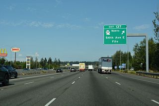 South from Exit 137, 54th Avenue E curves onto Valley Road southeast to North Puyallup. SR 99 north joins Pacific Highway east from 54th Avenue E nearby. Turning north, state route parallels I-5 through west Milton into Federal Way in King County.