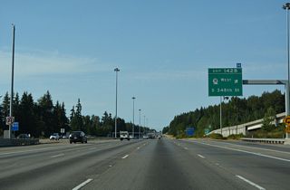 Exit 142 B loops onto SR 18 (S 348th Street) ahead of a heavily commercialized area 0.54 miles west to SR 99 (Pacific Highway). 348th Street continues beyond the state route portion to West Hylebos State Park, St. Francis Hospital, and Campus Drive.
