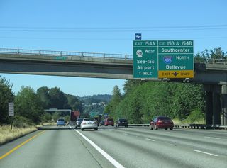 Interstate 5 north lowers to the interchange complex (Exits 153-154) with Tukwila Parkway, Interstate 405 north, and SR 518 west.