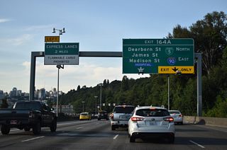 Exit 164 A, the 1.77 mile long collector distributor roadway north to the Freeway Park tunnel, was temporarily referenced as Business Loop I-5 from 2018 to 2024. The c/d roadway provides access to I-90 east in addition to Dearborn, James, and Madison Streets. Beginning at 4th Avenue S (SR 519) by Lumen Field and the International District, I-90 arcs southeast to meet I-5 near Yesler Terrace.