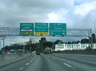 Interstate 5 angles northwest over Jackson and King Streets before the Express Lanes begin, 0.75 miles from Exit 165 to Seneca Street and Downtown Seattle. Extending 7.14 miles north to Exit 173 at Northgate, the reversible Express Lanes run between the north and southbound roadways.