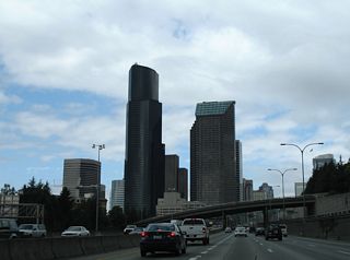 Yesler Way passes over Interstate 5 in the foreground while Columbia Center dominates the Seattle skyline.