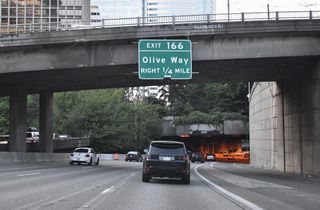 Exit 166 is next in a quarter mile for Olive Way and Capitol Hill. The directional T interchange (Exit 167) with the Mercer Street connector near Lake Union follows.