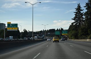 The Express Lanes ramp to SR 522 (Lake City Way) ascends over the northbound mainline to the beginning of the state route.