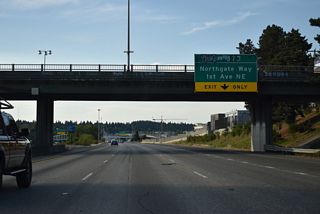 Ramps from both the Express Lanes and Interstate 5 northbound mainline lead onto adjacent 1st Avenue NE at Northgate Station. The Northgate Station commercial center replaced what was Northgate Mall.