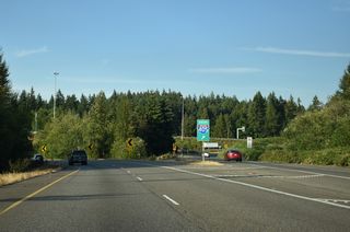 SR 525 north meets Alderwood Mall Parkway north of a retail area anchored by Alderwood Mall.