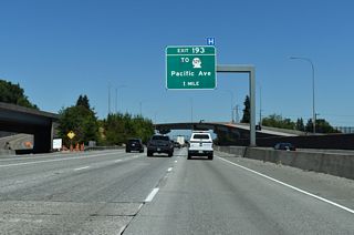 Curving northeast alongside a Union Pacific Railroad, I-5 advances one mile north to a half diamond interchange (Ext 193) with Pacific Avenue.