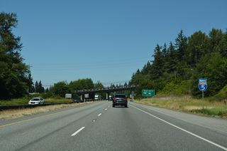 Located along Kincaid Street adjacent to Exit 226, Skagit Station provides multimodal transportation options from Mount Vernon. Blackburn Road passes over I-5 by Hillcrest Park beyond this confirming marker.