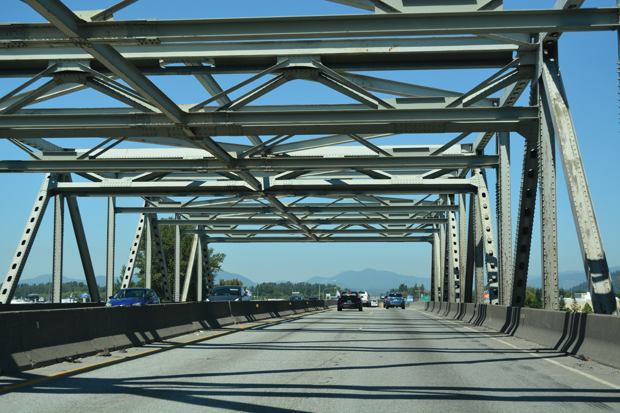 A portion of the Skagit River bridge on I-5 collapsed when a semi-truck collided with critical steel support members on May 23, 2013. The bridge was closed to mid-June, when a temporary span was placed to restore the crossing to service.1
