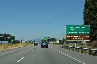 SR 20 leads 12 miles west to the city of Anacortes and SR 20 Spur, a 7.78 mile route to the Anacortes Ferry Terminal. A system of ferry routes joins Anacortes with the San Juan Islands and Sidney, British Columbia.