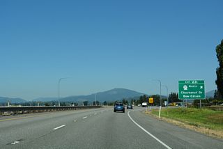 Exit 231 is a folded diamond interchange with roundabouts at Burlington Road and Josh Wilson Road. SR 11 angles northwest along Chuckanut Drive to Allen, Edison and Bow.