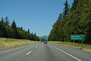 Distance sign posted 16 miles south of Bellingham and 71 miles out from Vancouver, British Columbia.
