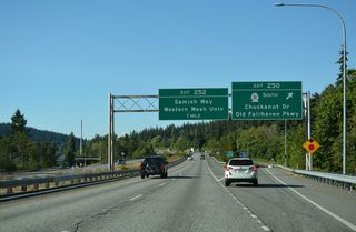 Curving north into Happy Valley, I-5 lowers to the diamond interchange (Exit 250) with SR 11 (Old Fairhaven Parkway) and Connelly Avenue east to 36th Street.