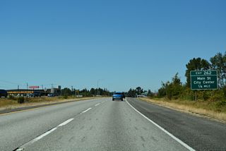 The parclo interchange at Exit 262 connects Interstate 5 north with Main Street at Barrett Road S (Old U.S. 99).