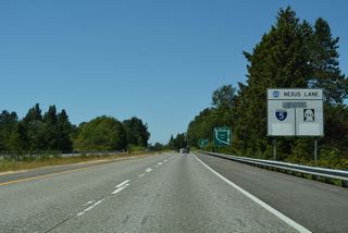 This Nexus Lane sign for the I-5 and SR 543 border crossings remained partially covered as of May 2025.