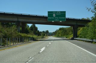 SR 548 (Peace Portal Drive) concludes north of Downtown Blaine at a dumbbell interchange (Exit 276) with I-5. U.S. 99 originally followed Peace Portal Drive to D Street and a turn into Peace Arch State Park.