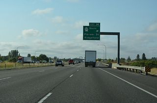 A diamond interchange (Exit 14) links Interstate 5 south with SR 501 (Pioneer Street) west at Ridgefield. Roundabouts join Pioneer Street east with S 65th Avenue and  NE 259th Street. 1.4 miles east of I-5, N 85th Avenue is Old U.S. 99/830.