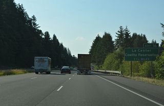 Gaining elevation, I-5 advances 1.75 miles south to Exit 16 for NW La Center Road and the community of La Center. Guide signs for Exit 16 previously referenced NW 319th Street.