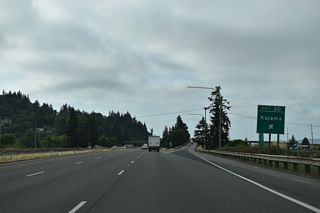 Oak Street crosses the BNSF Railroad to an industrial area along the Columbia River to the south. Frontage Roads lead south to the ramps at Elm Street; 1st Street (old U.S. 99/830) parallels one block to the east.