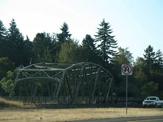 Adjacent Kelso Drive spans the Coweeman River across a two lane truss bridgealong the east side of Interstate 5. This bridge opened in 1947 as part of the original U.S. 99 Kelso bypass (Bozanich, n.d.-b).