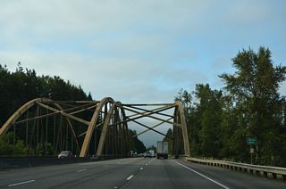 Advancing to the Toutle River along Interstate 5 south. The BNSF Railroad spans the river nearby along a truss bridge to the west.