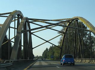 Tied arch bridges carry Interstate 5 over the Toutle River. These spans opened in 1969 when Interstate 5 extended the U.S. 99 expressway south from Exit 57.