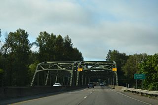 A pair of truss bridges take Interstate 5 across the Cowlitz River south of Exit 59. The bridges were constructed as a part of a U.S. 99 expressway from Chehalis south to near the Toutle River in 1953 (Bozanich, n.d.).
