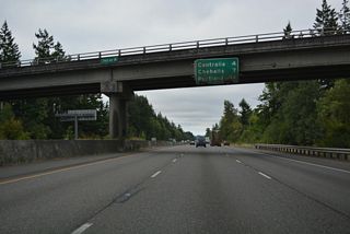 Distance sign at the 216th Avenue SW overpass on I-5/U.S. 12 south. Centralia is four miles away while I-5 reaches Portland in less than 100 miles.