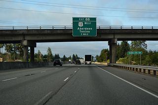 Interstate 5 lowers onto Grand Mound Prairie ahead of a diamond interchange (Exit 88) with U.S. 12 west and Old Highway 99 north.