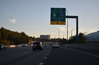 Interstate 5 lowers a quarter mile to the multi level interchange (Exit 133) with I-705 north and SR 7 south. 1.50 miles in length, Interstate 705 constitutes the  Tacoma Spur to the city center and Schuster Parkway along Commencement Bay.