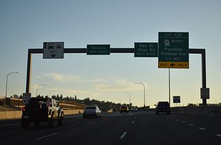 Spanning the Puyallup River, Interstate 5 continues to the split diamond interchange with Portland Avenue. SR 167 (Bay Street west / 28th Street east) converges with I-5 at a wye interchange within the exchange at Exit 135.