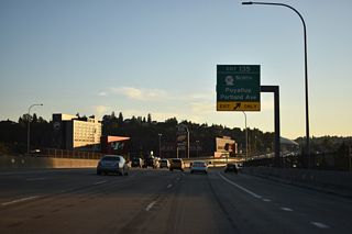 Exit 135 forms E 27th Street west, a frontage road providing access to Bay Street east to SR 167 and Portland Avenue. Portland Avenue travels north along the Puyallup River to the Port of Tacoma area and south to southeast Tacoma and SR 512 near Midland.