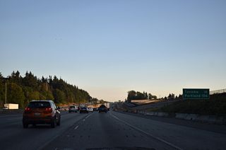 Southbound distance sign posted 16 miles north of Tacoma and 156 miles from Portland, Oregon. This stretch of Interstate 5 was previously expanded as part of the I-5 - SR 509 Corridor Completion and Freight Improvement Project.