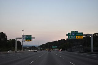 Exit 154 B parts ways with I-5 south for Southcenter Mall and Seattle-Tacoma International Airport (SEA). SR 518 leads west through SeaTac to 148th Street near the Burien city center.