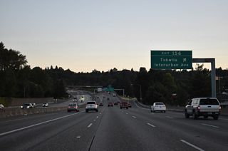 Interurban Avenue heads north from Exit 156 to E Marginal Way near Duwamish and south to I-405 and SR 181 (West Valley Highway) in east Tukwila. The avenue was originally part of an extended SR 181 to Boeing Access Road (AARoads Wiki, 2023).