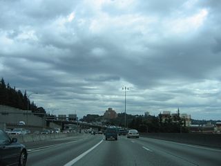 The 7.14 mile long Interstate 5 Express Lanes rejoin the general travel lanes  ahead of Yesler Way.