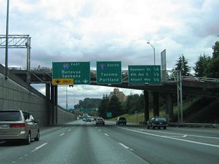 Forming an auxiliary lane to Dearborn Street, an entrance ramp joins the c/d roadway from parallel 6th Avenue at the Yesler Way overpass. The left lanes eventually join I-90 east to the Mercer Island Floating Bridge across Lake Washington and I-405 at Bellevue. I-90 is the main route across the Cascade Mountains in Washington, utilizing Snoqualmie Pass at an elevation of 3,022 feet.