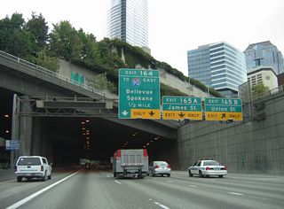 Exit 165 A to James Street follows onto parallel 6th Avenue at Columbia Street. James Street angles northeast from Yesler Way in Pioneer Square to Cherry Street at Seattle University. Exit 164 leaves in a half mile for Interstate 90 east to Spokane.