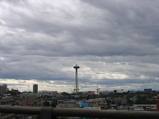The Seattle Space Needle rising from Seattle Center comes into view west of the Interstate 5 viaduct near Mercer Street.