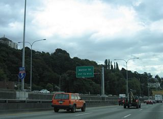 The exit for Mercer Street from the southbound Express Lanes drops below grade and combines with Exit 167 ahead of the signalized intersection with Fairview Avenue.