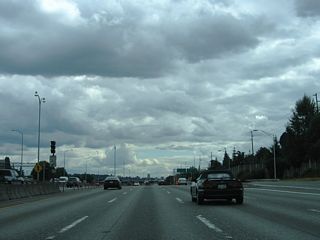 An entrance ramp from Ravenna Boulevard emerges from below Interstate 5, providing access to both the general travel lanes and Express Lanes roadway.