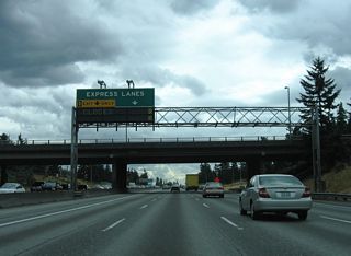 1.2 miles ahead of the Express Lanes, another half diamond interchange (Exit 174) adds traffic to I-5 south from NE 130th Street by Northacres Park. The reversible roadway shifts direction on a weekly schedule to aid in peak hour traffic or during special events.