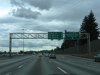 The three quarter cloverleaf interchange joining I-5 and Northgate Way utilizes connections with adjacent 1st Avenue NE and Corliss Avenue NE. Exit 173 to Meridian Avenue south leads to North Seattle Community College.